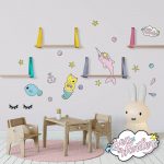Sea creature wall decals featuring narwal, mermaid kitten and pufferfish in a baby nursery.