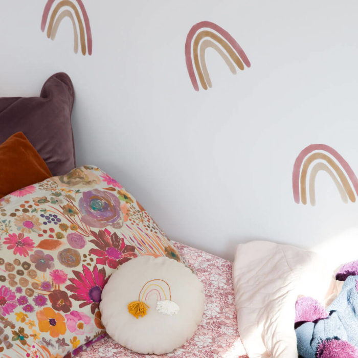 Close up of medium dusty rainbow wall decals in a girl's bedroom.